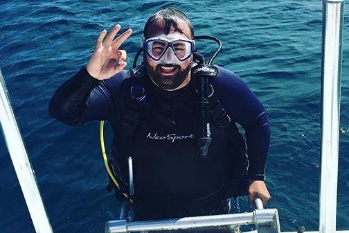 a person standing next to a body of water