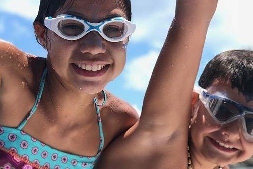 a woman wearing sunglasses posing for the camera
