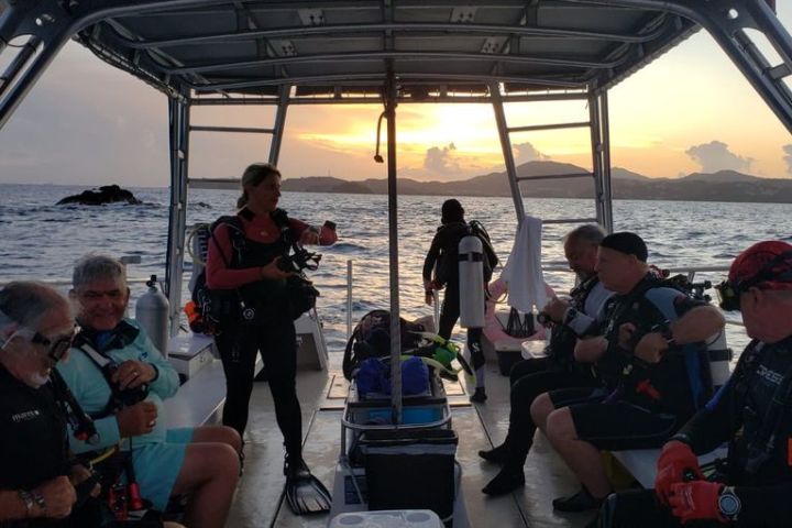 Divers on boat preparing for night dive