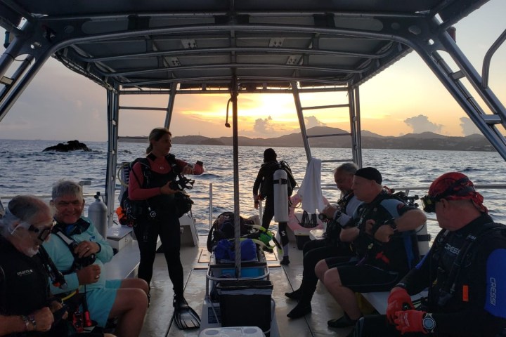 a group of people standing next to a body of water